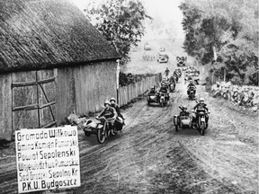 A motorcycle unit of the Nazi Army, followed by trucks, is shown during the German invasion of Poland in Sept. 1939 in World War II.  The sign proclaims they are near Bydgoszcz, Bromberg, and its suburbs.  This photo was taken by an official photographer with the German army and was passed by both the German and British censors and flown to New York.