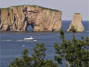 A sightseeing ship passes by the Perce rock, landmark of the Gaspé region.