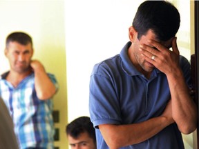 Abdullah Kurdi, 40, father of Syrian boys Alan, 3, and Galip, 5, who were washed up drowned on a beach near Turkish resort of Bodrum on Wednesday, cries as he waits for the delivery of their bodies Sept. 3, 2015.