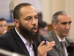 Adil Charkaoui speaks at a legislature committee studying a bill on hate speech on Tuesday, September 15, 2015 at the legislature in Quebec City. Douelmaken Cheblaoui sits by his side.