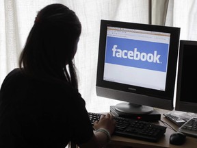 An unidentified 11-year-old girl looks at Facebook on her computer at her home in Palo Alto, Calif.