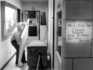 A  Concordia University worker prepares a new door for the offices of the Mechanical Engineering department August 25, 1992 after the shootings by Valery Fabrikant. The old door was riddled with bullet holes and had to be replaced. The sign at right indicated the department was temporarily closed.