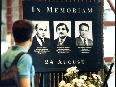 A man pauses in front of a makeshift memorial to three victims of Valery Fabrikant on August 27, 1992.