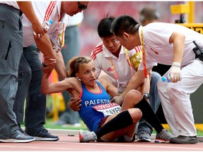 Mayada Al Sayed of Palestine collapses with exhaustion after crossing the finish line in the Women's Marathon final at the 15th IAAF World Athletics Championships Beijing 2015 on August 30, 2015 in Beijing, China. Self-talk plays a key role in making it to the end of the race.