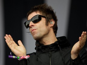 British singer Liam Gallagher gestures to the crowed while performing with his band Beady Eye on third day of the Glastonbury Festival of Contemporary Performing Arts near Glastonbury, southwest England in this June 28, 2013 photo.