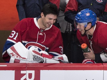 Montreal Canadiens' goalie Carey Price, left, shares a laugh with teammate Alexei Emelin while sitting on the bench as they face the Toronto Maple Leafs during second period NHL pre-season hockey action Tuesday, September 22, 2015, in Montreal.