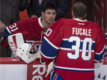 Montreal Canadiens' goalie Carey Price, left, chats with his replacement Zacahry Fucale during a break in play as they face the Toronto Maple Leafs during second period NHL pre-season hockey action Tuesday, September 22, 2015, in Montreal.