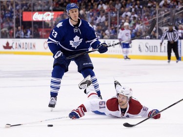 Montreal Canadiens forward David Desharnais, right, reaches for the puck after being tripped by Toronto Maple Leafs forward Shawn Matthias during first period pre-season exhibition NHL hockey action in Toronto on Saturday, September 26, 2015.