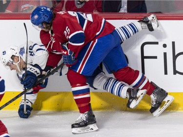 Toronto Maple Leafs' Dmytro Timashov, left, is taken out by Montreal Canadiens' Jeff Petry during second period NHL pre-season hockey action Tuesday, September 22, 2015, in Montreal.