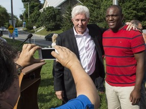Bloc Québécois leader Gilles Duceppe stops for a photograph with a supporter following a news conference Thursday, Sept. 10, 2015, in Beloeil.
