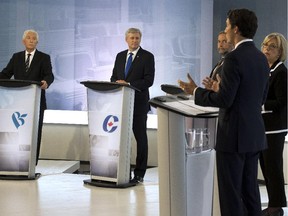 Bloc Québécois Leader Gilles Duceppe, left to right, Conservative Leader Stephen Harper, NDP Leader Tom Mulcair, Green Party Leader Elizabeth May and Liberal Leader Justin Trudeau trade words during the French-language debate on Thursday, September 24, 2015, in Montreal.
