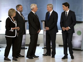 Green party Leader Elizabeth May, left to right, NDP Leader Tom Mulcair, Bloc Quebecois Leader Gilles Duceppe, Conservative Leader Stephen Harper, and Liberal Leader Justin Trudeau pose for photos before the French- language debate Thursday, Sept.24, 2015  in Montreal.