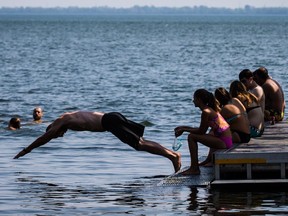 A man jumps into into the St. Lawrence river at the Verdun Natatorium during a heat wave in 2015.