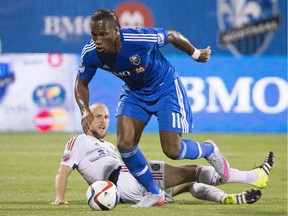 The Impact's Didier Drogba breaks away from Chicago Fire's Eric Gehrig to score his first MLS goal during action at Montreal's Saputo Stadium on Sept. 5, 2015. Drogra scored three goals in Montreal's 4-3 victory.