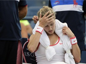 Canadian Eugenie Bouchard takes a break between games against Dominika Cibulkova of Slovakia during the third round of the U.S. Open tennis tournament, Friday, Sept. 4, 2015, in New York. Bouchard has withdrawn from the U.S. Open with a concussion.