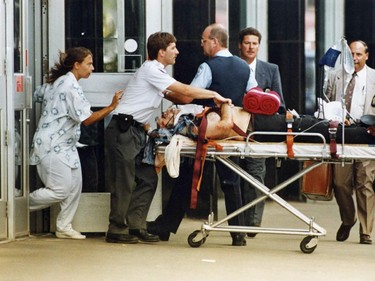 A wounded victim is wheeled out of Concordia University's Henry f. Hall Building on de Maissonneuve after professor Valery Fabrikant went on a shooting spree August 24, 1992.