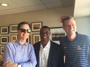 Former Expos player Warren Cromartie, now head of the Montreal Baseball Project (centre), poses with Boston Red Sox owner John Henry (left) and chief operating officer Sam Kennedy during trip to Boston on Sept. 7, 2015.