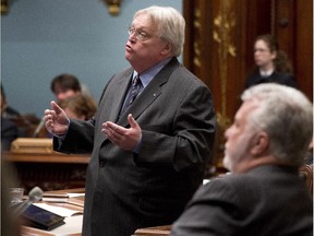 Quebec Health Minister Gaétan Barrette responds to Opposition questions as Quebec Premier Philippe Couillard, right, looks on.
