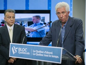 ADR TV President Vincent Geracitano, left, looks on as Bloc Quebecois Leader Gilles Duceppe speaks to the media at the offices of the televison channel that searches for missing people during a campaign stop in Montreal on Friday, September 4, 2015.