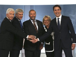 Bloc Québécois Leader Gilles Duceppe, left to right, Conservative Leader and Prime Minister Stephen Harper, New Democratic Party Leader Thomas Mulcair, Green Party Leader Elizabeth May and Liberal Leader Justin Trudeau shake hands before the start of the French-language leaders' debate in Montreal on Thursday, September 24, 2015. Canadians go to the polls in a federal election on October 19, 2015.