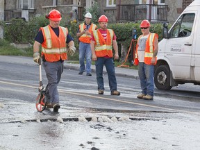 City workers respond to a water-main break near Plamondon métro in Montreal Sept. 17, 2015.