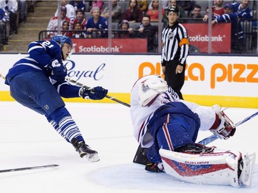 Toronto Maple Leafs' forward James van Riemsdyk, left, scores on Montreal Canadiens' goaltender Mike Condon during a three-on-three showcase period in pre-season exhibition NHL hockey action in Toronto on Saturday, September 26, 2015.