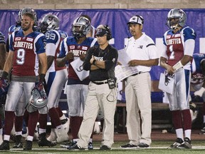 Alouettes general manager and head coach Jim Popp, centre, looks on from the sidelines alongside Anthony Calvillo during CFL game against the B.C. Lions at Molson Stadium on Sept. 3, 2015.