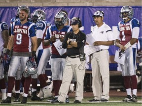 Montreal Alouettes' general manager and head coach Jim Popp, centre, looks on from the sidelines alongside quarterback coach Anthony Calvillo during first half CFL football action against the B.C. Lions in Montreal on Thursday, Sept. 3, 2015.