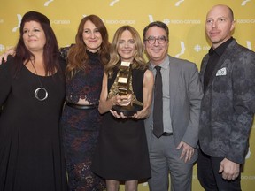 Julie Snyder, centre, along with members of her production team, holds up her trophy for best variety television series 'La Voix' at the annual Gala Gémeaux awards ceremony in Montreal, Sunday, Sept. 20, 2015.