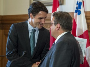 Liberal leader Justin Trudeau shakes hands with Montreal mayor Denis Coderre following a meeting at Montreal City Hall  back on September 3, 2015 in Montreal.