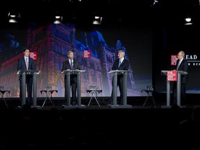 Liberal leader Justin Trudeau, left, NDP leader Tom Mulcair and Conservative leader Stephen Harper take part in the Globe and Mail hosted leaders' debate as moderator David Walmsley, right, looks on Thursday, September 17, 2015  in Calgary.