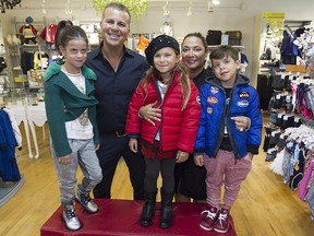 Melissa Waskiw, left, Zoe Tsaprailis, centre, and Johnny Waskiw, with Kid Biz owners Chris Paras and Maria Bitzilou at the store in Laval. The children, all 6 years old, are wearing a selection of the high-end styles available at the store, which is celebrating its 20th anniversary this year.