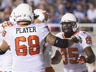 B.C. Lions players celebrate a touchdown by Lavelle Hawkins during first half CFL football action against the Montreal Alouettes in Montreal on Thursday, September 3, 2015.