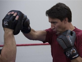 Liberal leader Justin Trudeau does a boxing workout with trainer Kevin Reynoles in downtown Vancouver, B.C., Thursday, Sept, 10, 2015.