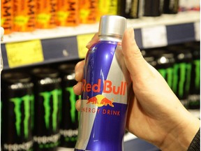 A customer holds a Red Bull can.