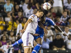 Los Angeles Galaxy defender Omar Gonzalez, left, and  Impact forward Didier Drogba battle for a header during MLS game in Carson, Calif., on Sept. 12, 2015. The game ended in a 0-0 draw.