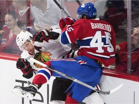 Canadiens defenceman Mark Barberio checks Chicago Blackhawks' Daniel Paille during NHL pre-season game at Montreal's Bell Centre on Sept. 25, 2015.