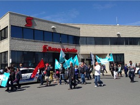 Members of the Quebec Provincial Association of Teachers march to protest changes to the education system. They were outside MNA Geoff Kelley's offices on St-Jean Blvd. on May 1.