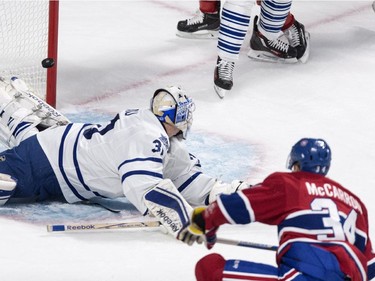 Montreal Canadiens' Michael McCarron, right, scores past Toronto Maple Leafs' goalie Antoine Bibeau during first period NHL pre-season hockey action Tuesday, September 22, 2015 in Montreal.