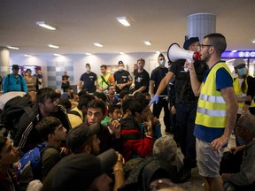 Migrants and refugees  wait at the Keleti Railway Station in Budapest, Hungary, Sunday, Sept. 13, 2015.