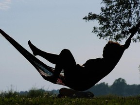 Lucie Charbonneau beats the heat with a book and a hammock in Lachine in 2015.