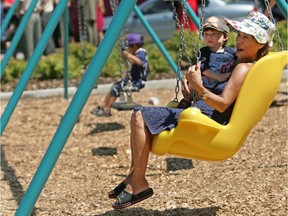 Linda Wylie and grandson Angelo Caimano find a swing specially adapated for a child in a wheelchair the perfect place to relax in Benny Park in N.D.G. The playground has been adapted for kids with handicaps.