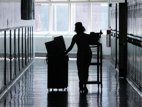 A teacher wheels computers to her class.