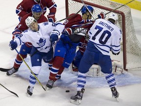 Montreal Canadiens defenceman Travis Brown (90) gets roughed up by Toronto Maple Leafs forwards TJ Foster (68) and Frederik Gauthier (70) in front of the Montreal net during their NHL Rookie Tournament hockey game at Budweiser Gardens in London, Ont., on Saturday, September 12, 2015.