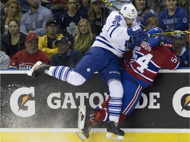 Montreal Canadiens forward Charles Hudon is checked into the boards by Toronto Maple Leafs defenseman Cameron Lizotte during their NHL Rookie Tournament hockey game at Budweiser Gardens in London, Ont., on Saturday, September 12, 2015.