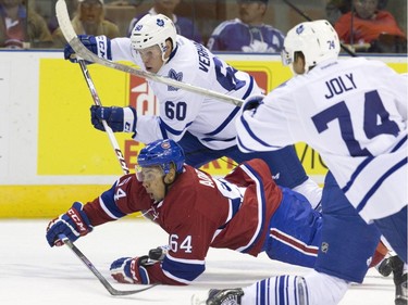 Montreal Canadiens forward Jeremiah Addison chases down a loose puck while under pressure from Toronto Maple Leafs forwards Carter Verhaeghe (60) and Michael Joly (74) during their NHL Rookie Tournament hockey game at Budweiser Gardens in London, Ont., on Saturday, September 12, 2015.