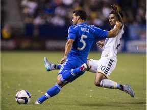 Montreal Impact midfielder Dilly Duka shoots against Los Angeles Galaxy defender A.J. DeLagarza in the second half of an MLS soccer game in Carson, Calif., Saturday, Sept. 12, 2015.  The game ended in a 0-0 draw.