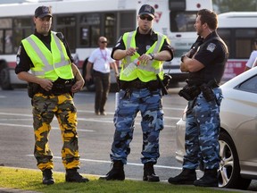 Police officers in fatigues act as security at the Jean Béliveau Coliseum in Longueuil on Aug. 1, 2014.