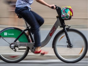 A cyclist rides a Bixi bicycle on de Maisonneuve Blvd.