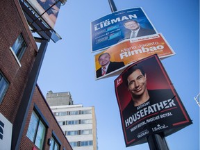 Top to bottom: Federal election campaign signs for candidates Robert Libman, with the Conservative Party, Mario Jacinto Rombao, with the NDP, and Anthony Housefather, with the Liberal Party, on Décarie Blvd. in the riding of Mount-Royal.